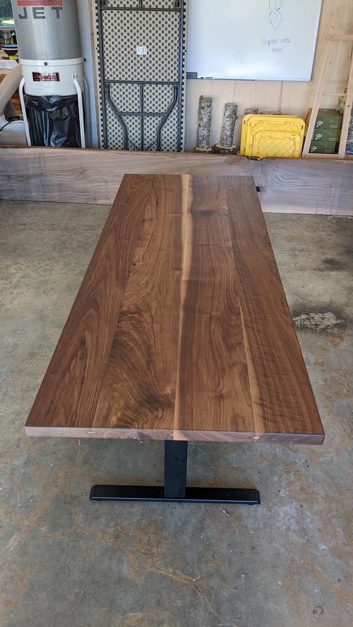 Walnut dining table with steel trestle base